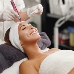 Shot of a beautiful young woman on a facial dermapen micro-needling treatment at the beauty salon.